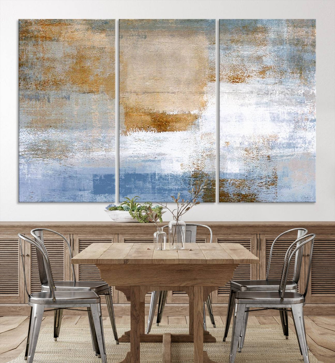 The Blue Multi Panel Abstract Wall Art Canvas Print, featuring an elegant blend of blue, beige, and brown tones, hangs gracefully on the wall, adding a contemporary touch to the space.