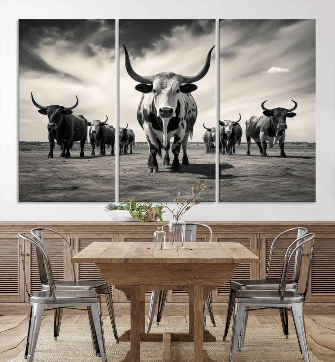 The Black and White Longhorn Cattle Wall Art, featuring a three-panel display of cowboy Western longhorns walking toward the viewer, enhances your space with its striking presence, adding a touch of Western decor.