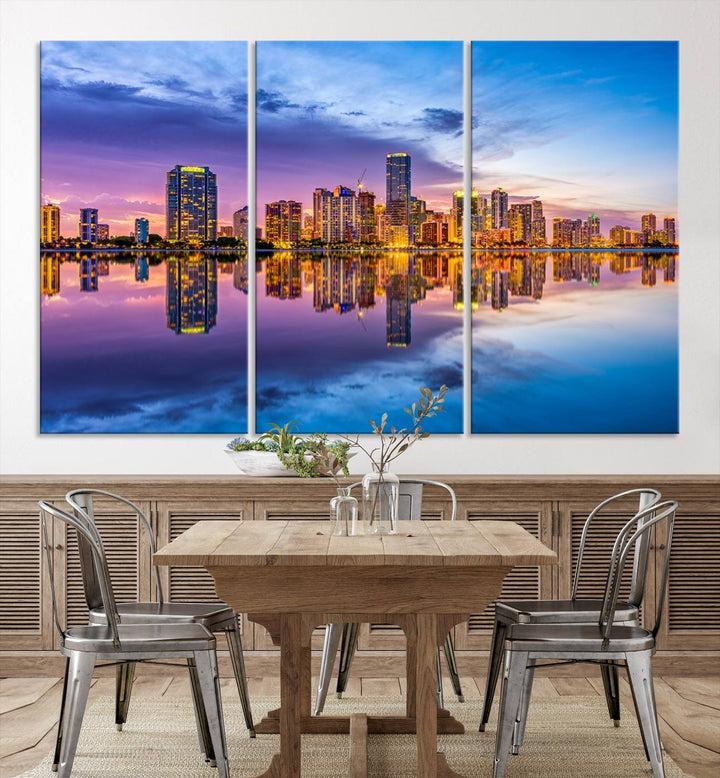 The Miami City Wall Art Canvas Print, featuring a three-panel depiction of a city skyline at sunset reflected in water, beautifully enhances the wall. Made with museum-quality canvas and a UV-protective coating, it comes ready to hang.