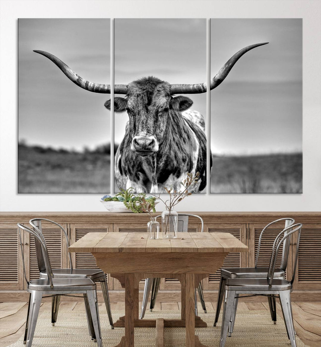 The Texas Longhorn Cow Wall Art, featuring a black and white image of a longhorn bull on canvas, brings charm to the room with its sophisticated appeal.