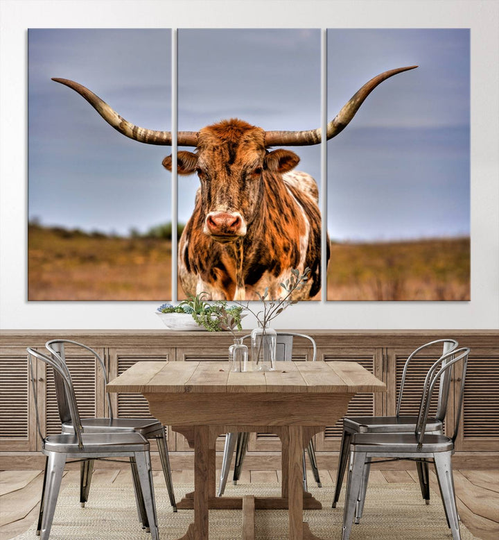 The Texas Longhorn Wall Art Print, a triptych canvas artwork depicting a longhorn bull in a field, features a gallery-quality finish.