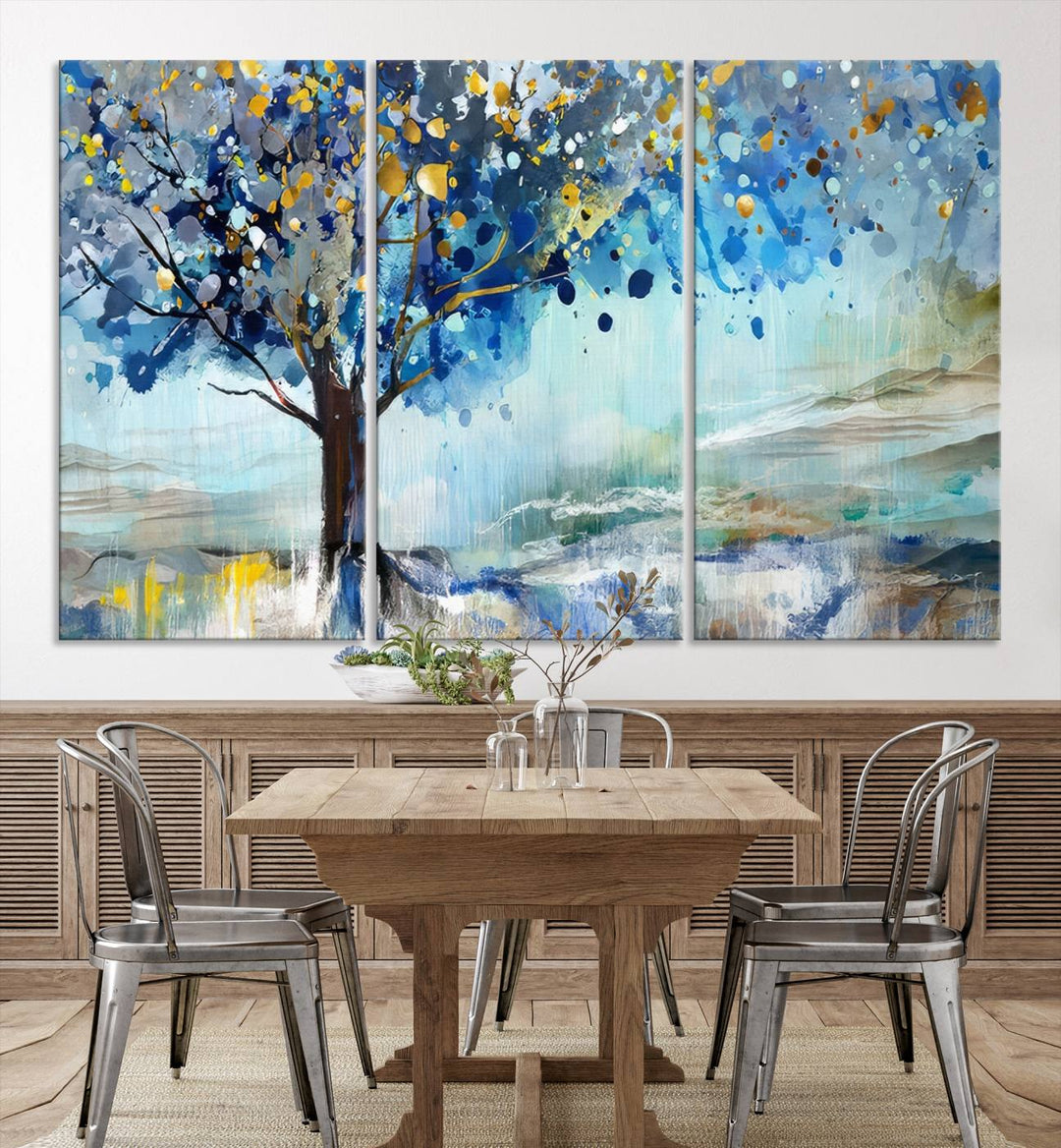 A modern living room features a three-panel Watercolor Style Abstract Tree Printing Wall Art Canvas in vibrant blue and yellow, crafted on museum-quality material.