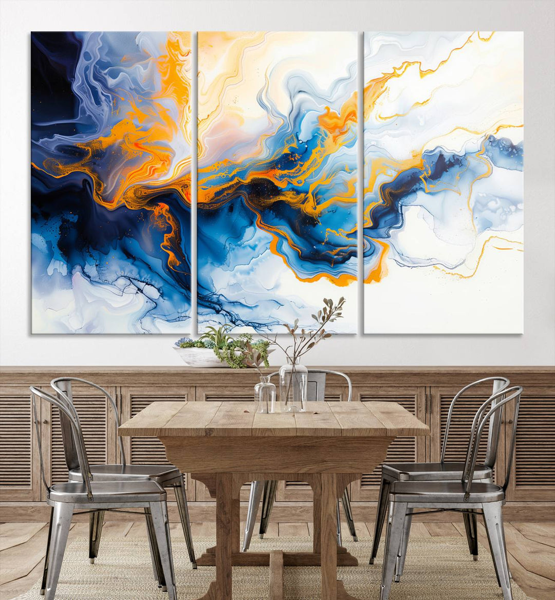 A stunning Fluid Alcohol Ink Wall Art with Gold Wall Art Canvas Print, featuring vibrant blue, orange, and white swirls, adorns the wall. This gallery-quality finish adds an exquisite touch to any living space.