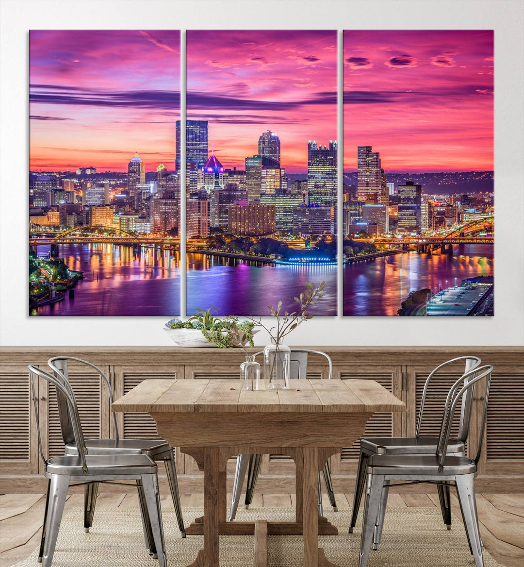 The Pittsburg Wall Art Canvas Print, showcasing a vibrant sunset glow over the city skyline and crafted by a professional artisan, adorns the space.