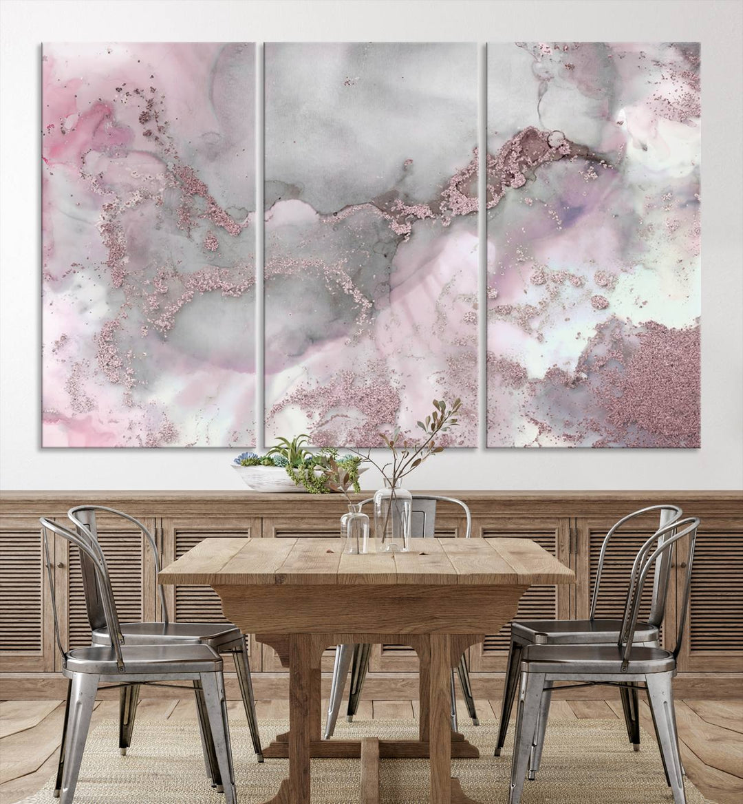 The Rose Marble Abstract Wall Art Canvas Print is a stunning triptych that showcases pink and gray tones, elegantly presented on a dark wall.