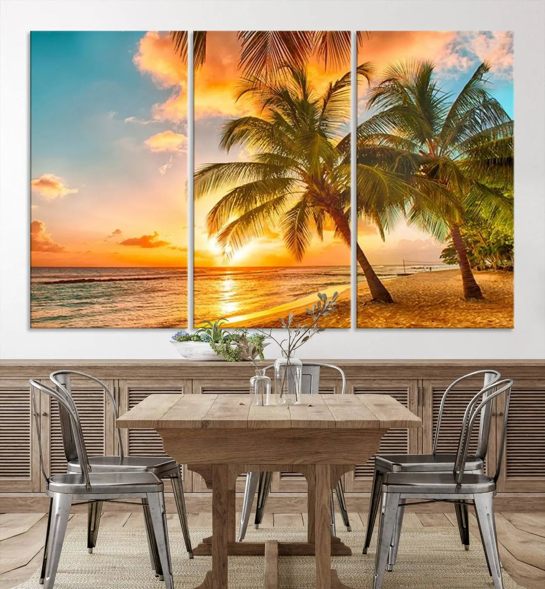 The Tropical Sunset Wall Art Print features a vibrant beach scene with palm trees and an ocean view highlighted by a golden sunset.