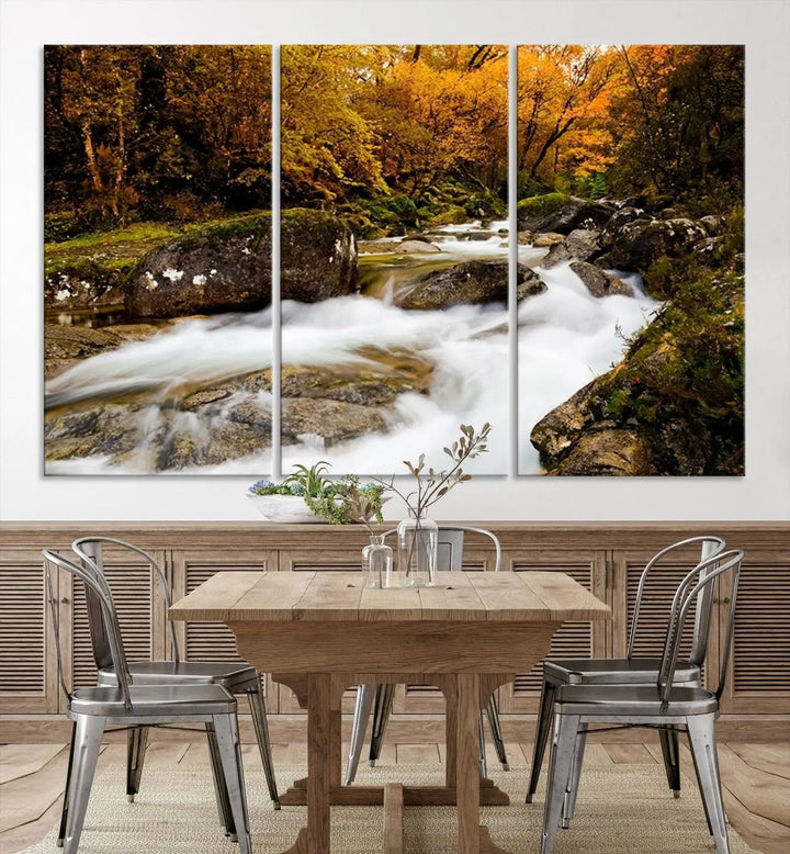 The living room is adorned with the "Wall Art Waterfall Canvas Print River in Forest in Autumn," a triptych on museum-quality canvas showcasing a flowing river surrounded by autumn trees. This ready-to-hang artwork features a UV-protective coating to ensure enduring vibrancy.