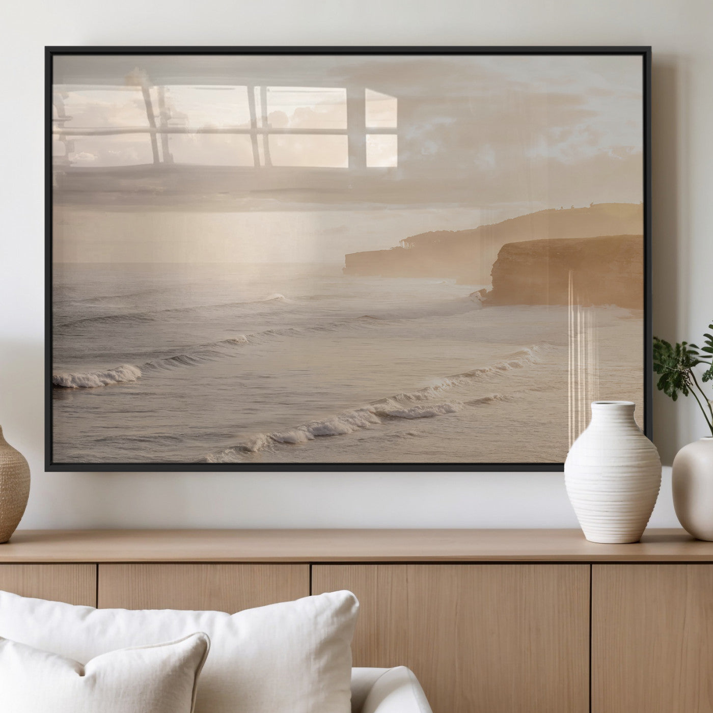 Golden hour seascape with misty cliffs and gentle waves rolling towards the shore, capturing a tranquil and warm coastal atmosphere.