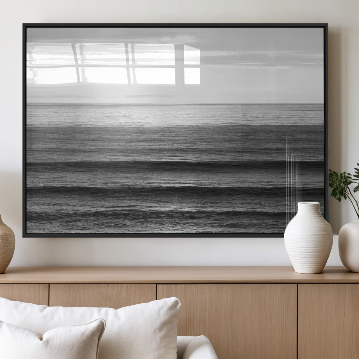 Minimalist black and white ocean view with layered waves reflecting sunlight, evoking a sense of calm and coastal serenity.