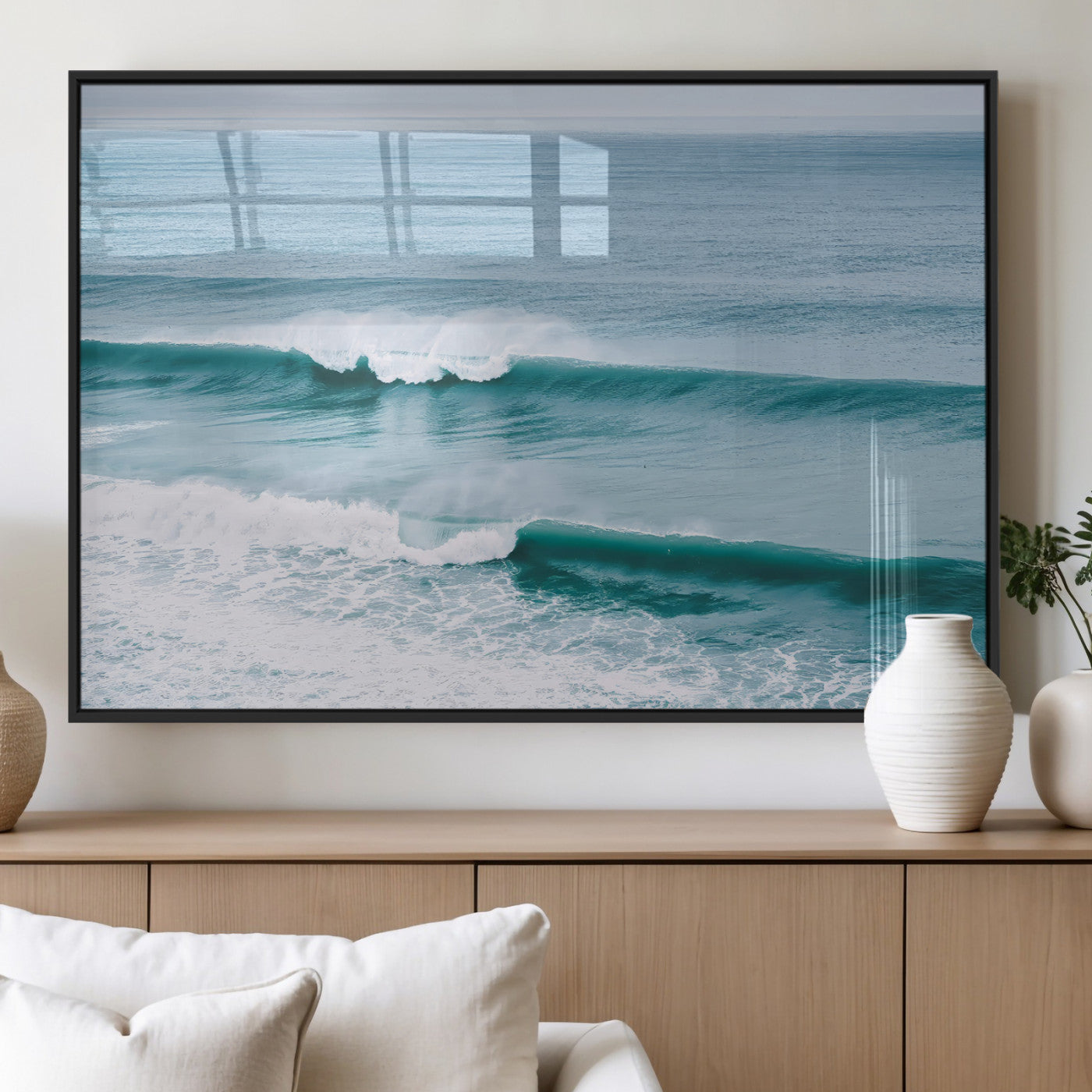 Powerful ocean waves rolling towards the shore, their turquoise hues blending with white sea foam under an open horizon, capturing the essence of the ocean's movement.