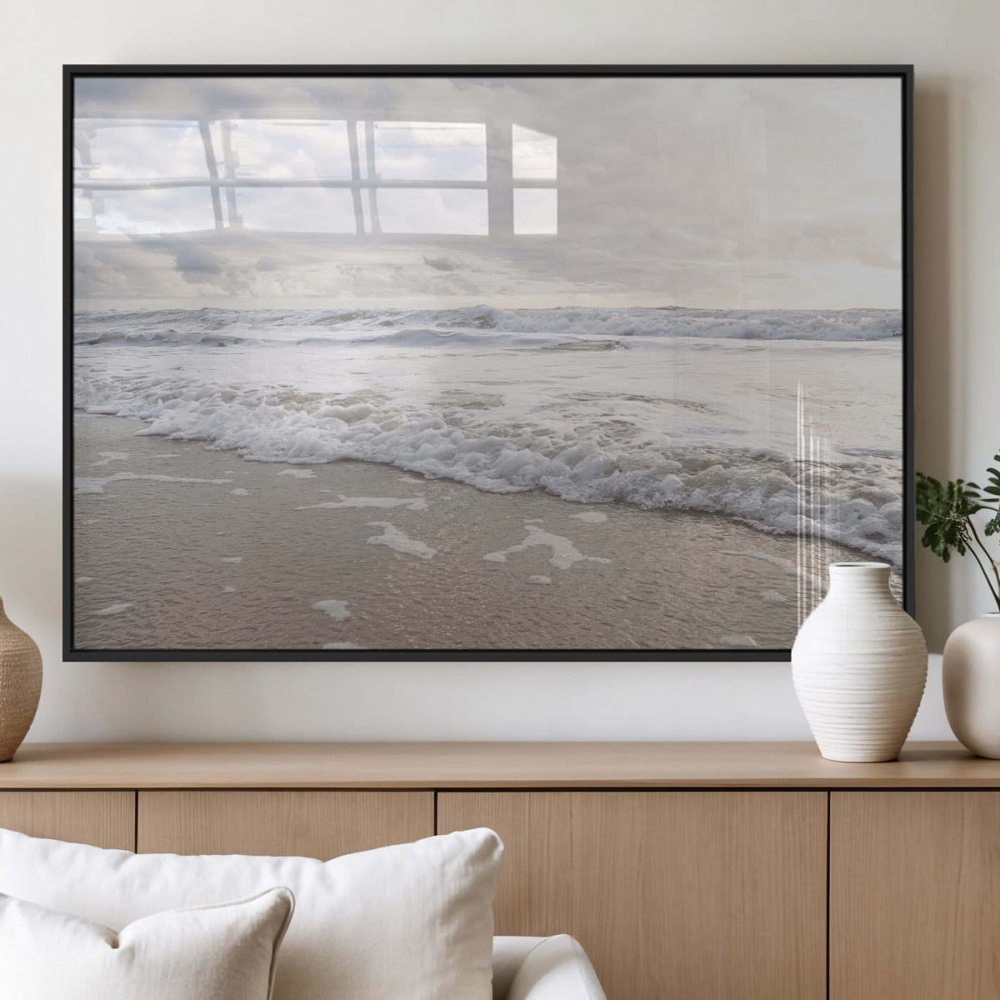 Peaceful ocean waves rolling onto the sandy shore under soft light, perfect for neutral or coastal minimalist decor themes.