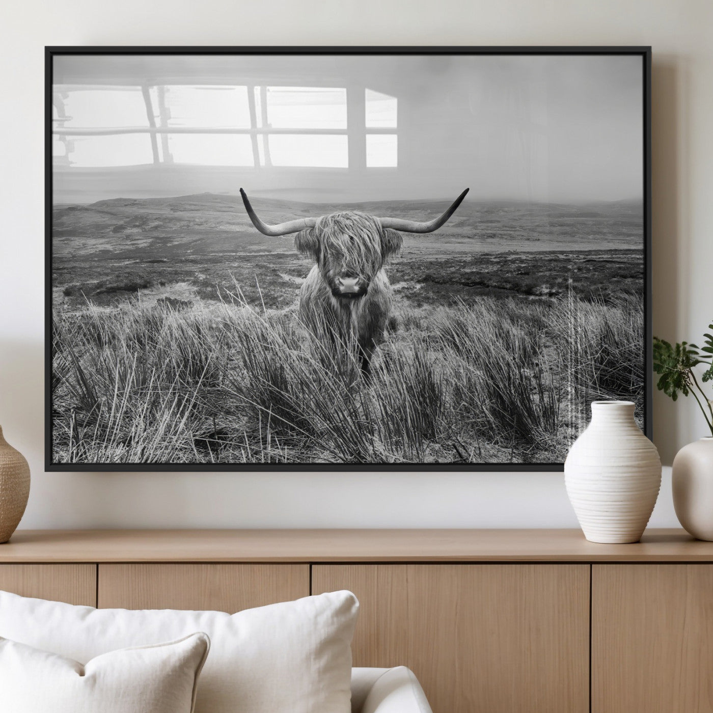 A black and white portrait of a Highland cow in a foggy Scottish countryside, capturing a rustic aesthetic and tranquil farm escape.