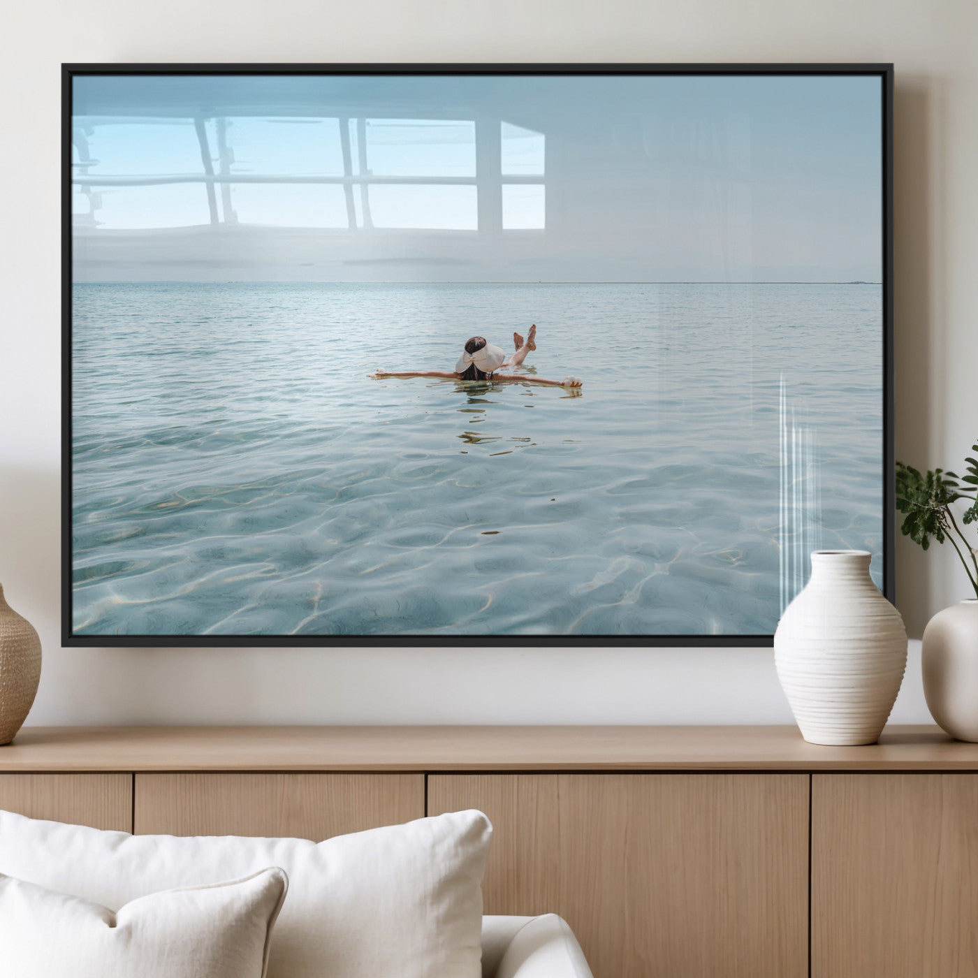 A peaceful minimalist scene of a person floating on crystal-clear water, surrounded by a vast open horizon, capturing relaxation and serenity in a tranquil aquatic setting.