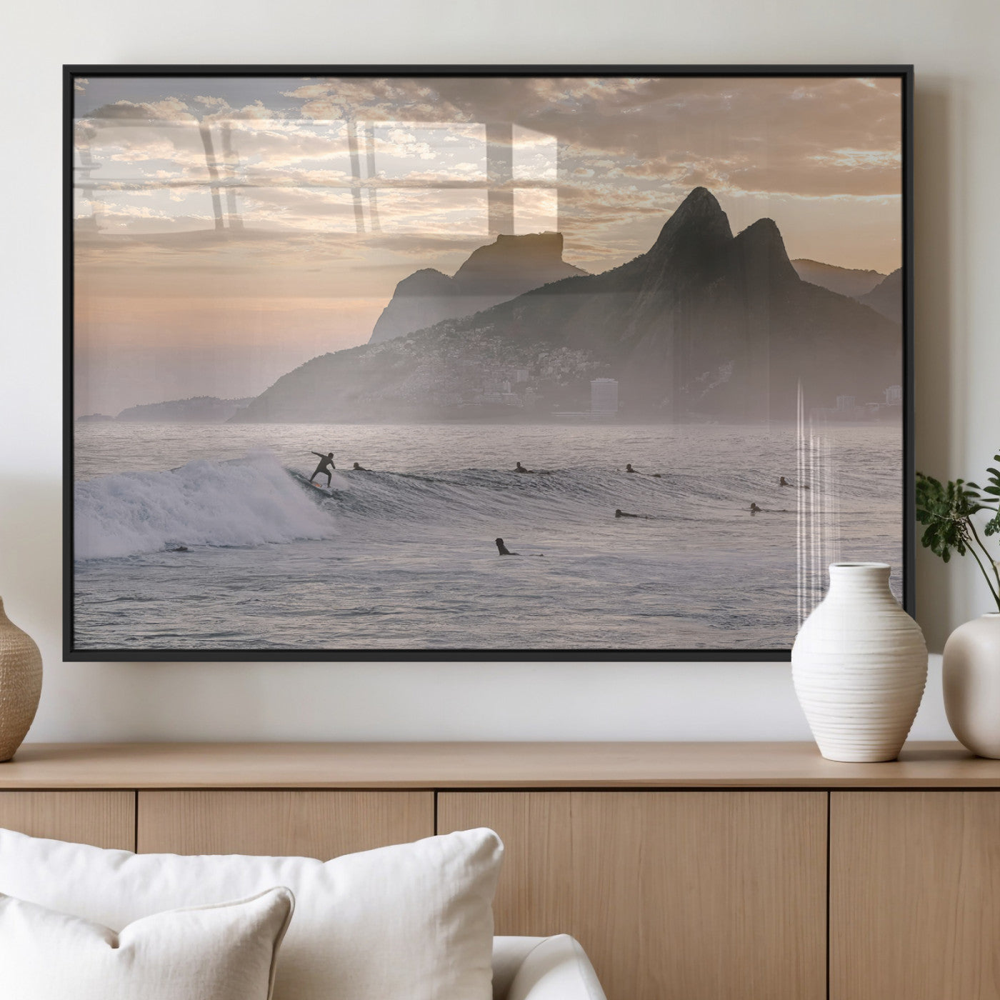 A surfer rides a golden hour wave near misty coastal mountains, surrounded by fellow surfers, capturing the spirit of a coastal adventure.