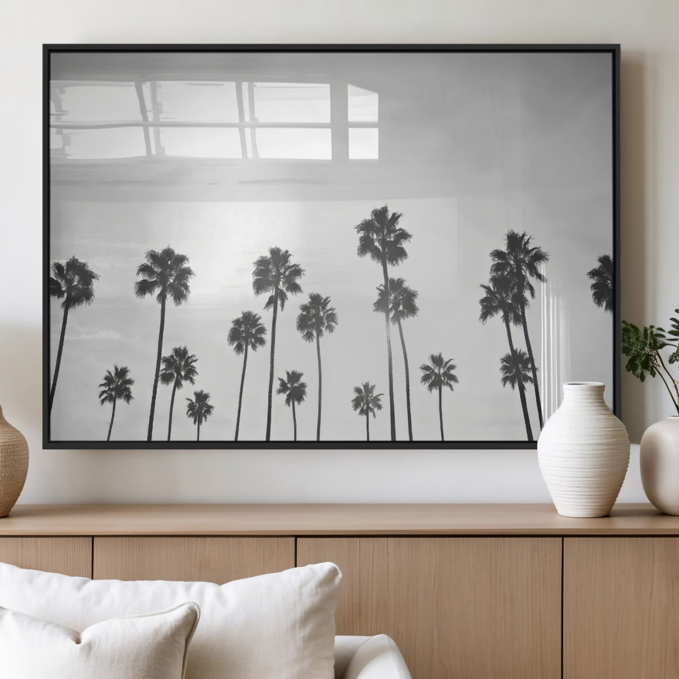 A black and white minimalist scene featuring tall palm trees silhouetted against a bright sky, creating a dreamy and timeless tropical aesthetic.