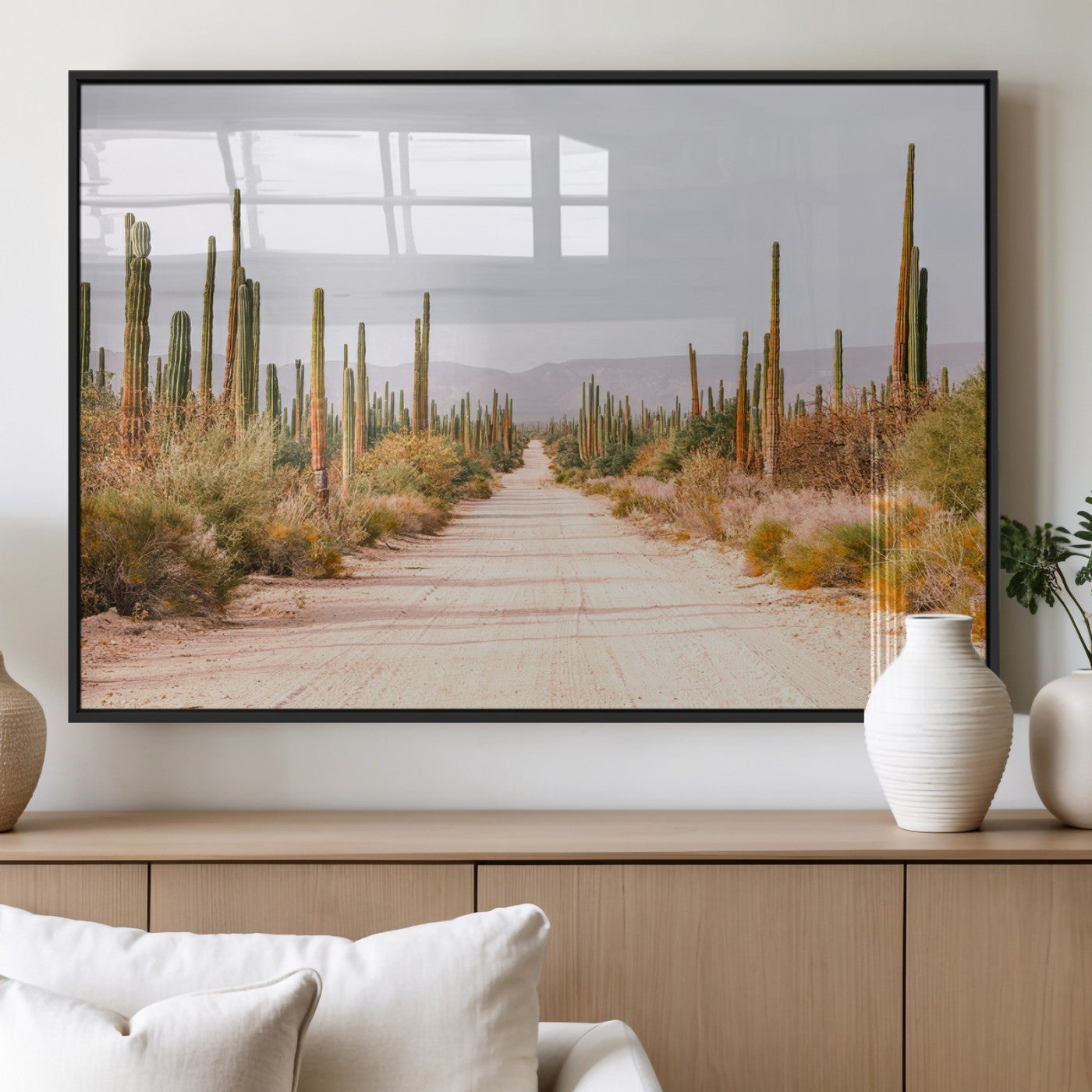 A desert road lined with saguaro cacti under a golden sky, creating a warm southwestern feel, perfect for boho or rustic decor.