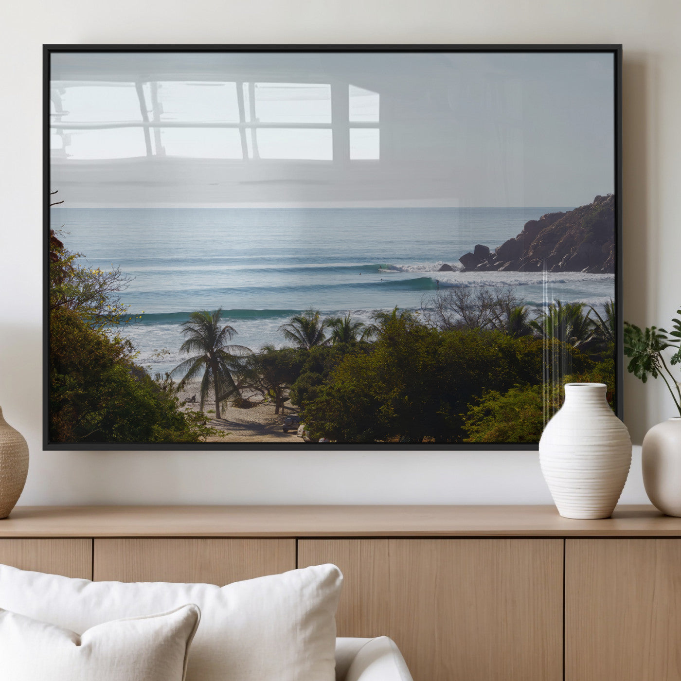 View of calm ocean waves with palm trees and a tropical coastline, ideal for coastal boho or beach-themed wall decor.
