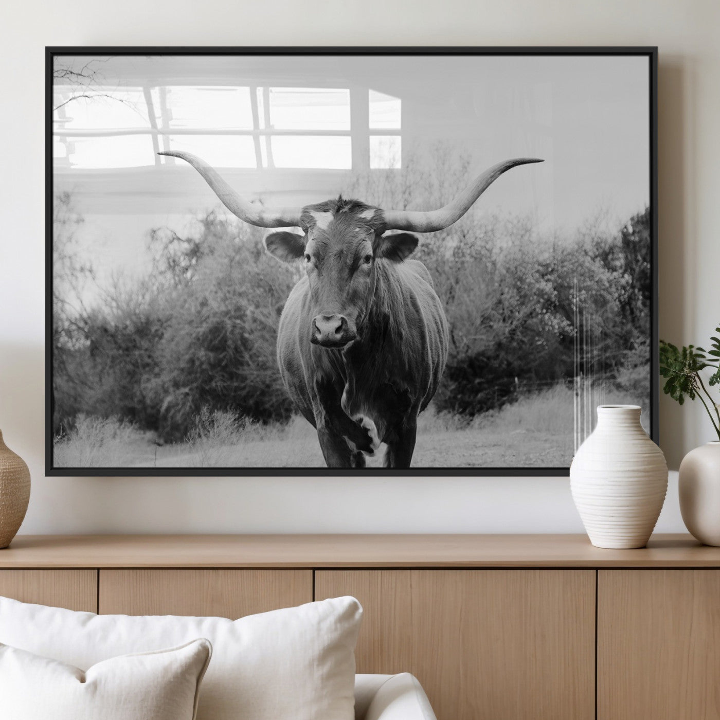 Black and white photo of a Longhorn cow facing camera, ideal for rustic, farmhouse, or western-themed home wall decor.