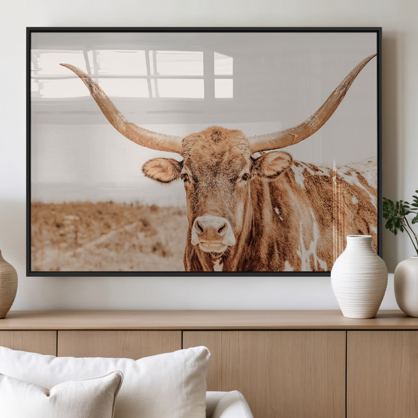 Sepia-toned Texas Longhorn facing forward in a dry field, perfect for rustic farmhouse or western-themed neutral home decor.