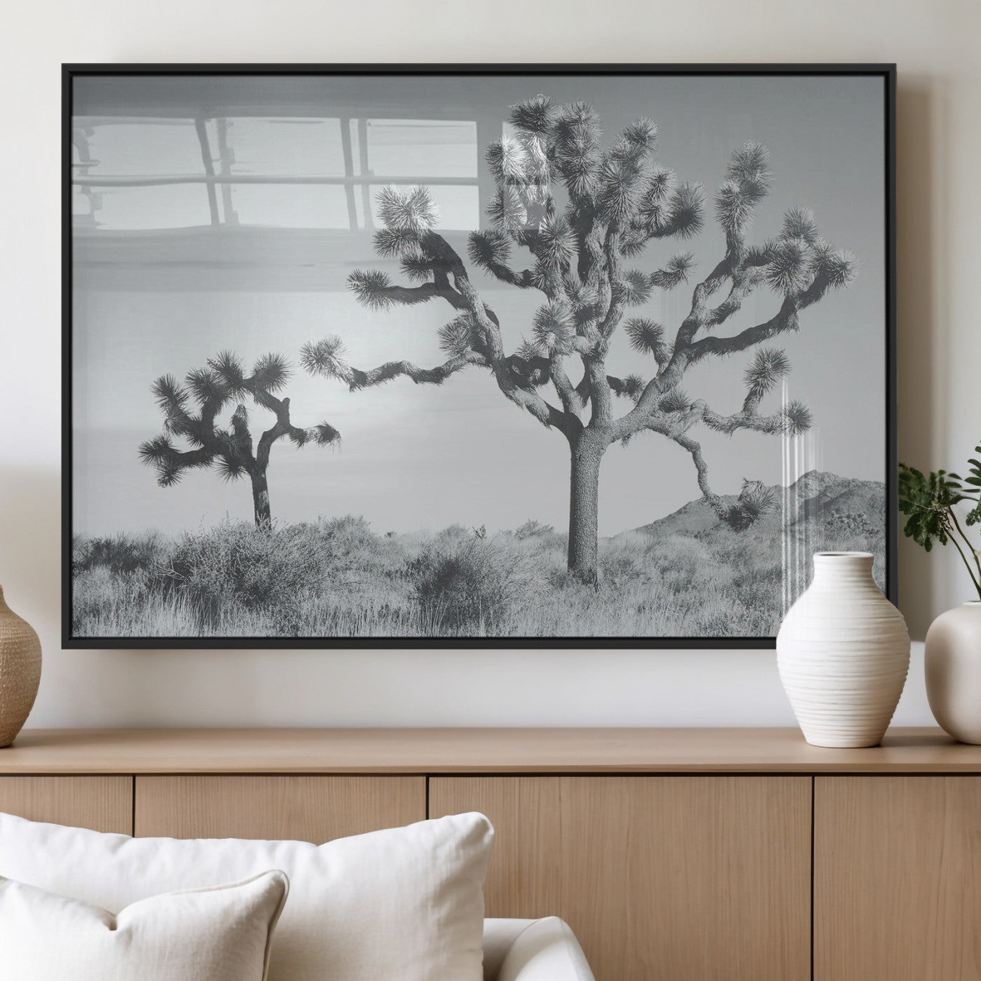 Two Joshua trees in a black and white desert landscape with distant hills, ideal for boho or rustic interior wall styling.