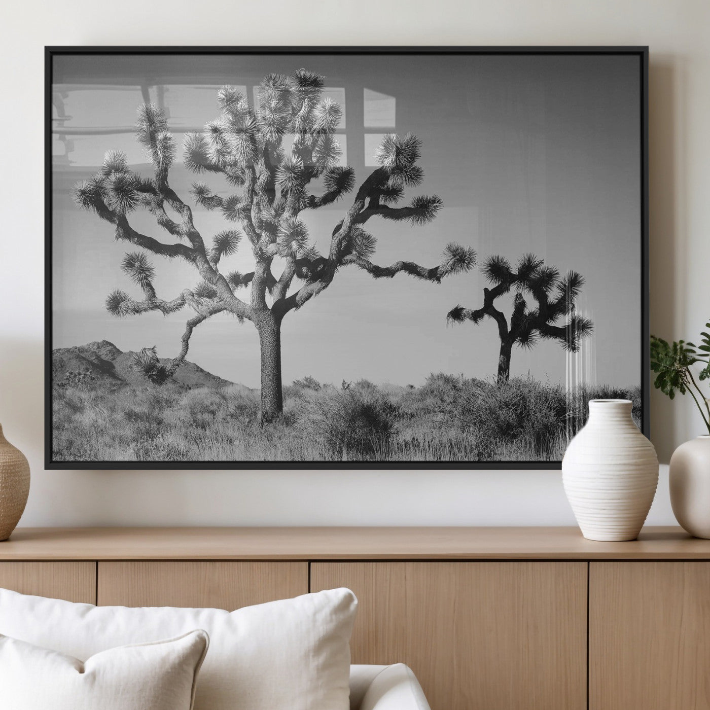 Black and white desert scene with two Joshua trees under clear sky, perfect for rustic or boho-inspired home decor.