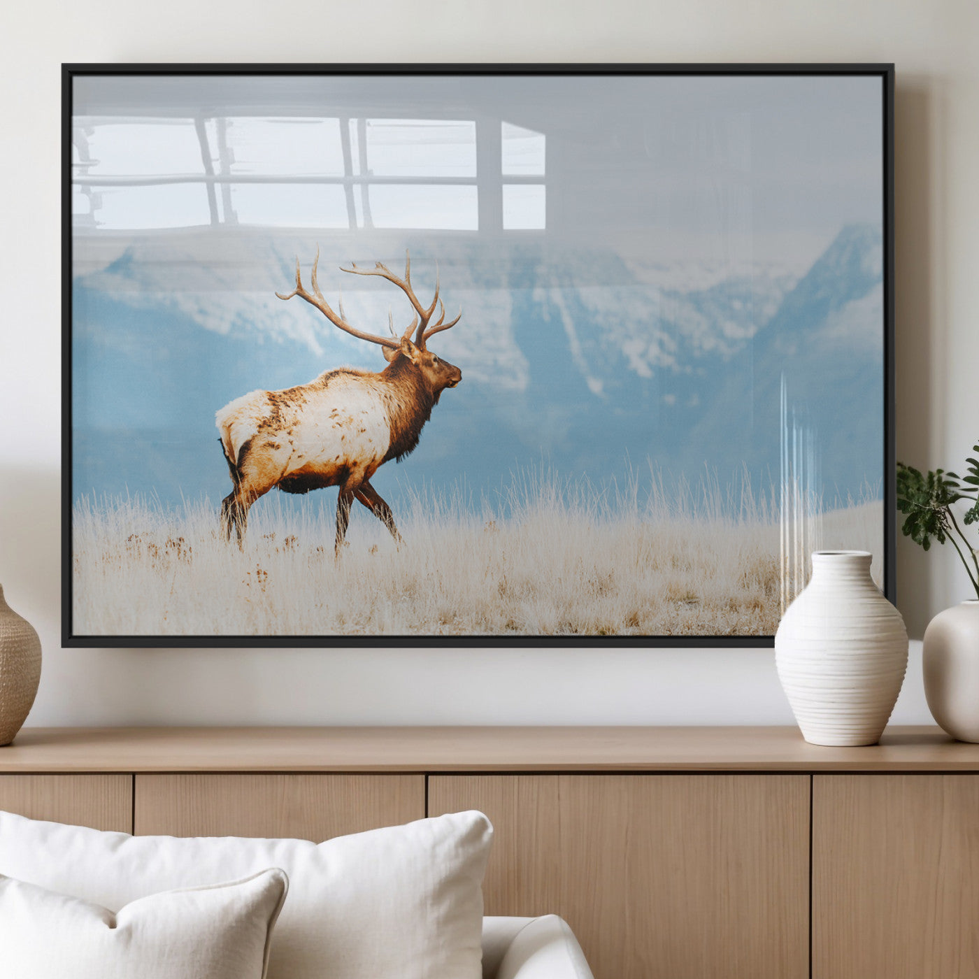 Majestic elk standing on dry grassland with snowy mountains in the background, ideal for rustic or lodge-inspired wall decor.
