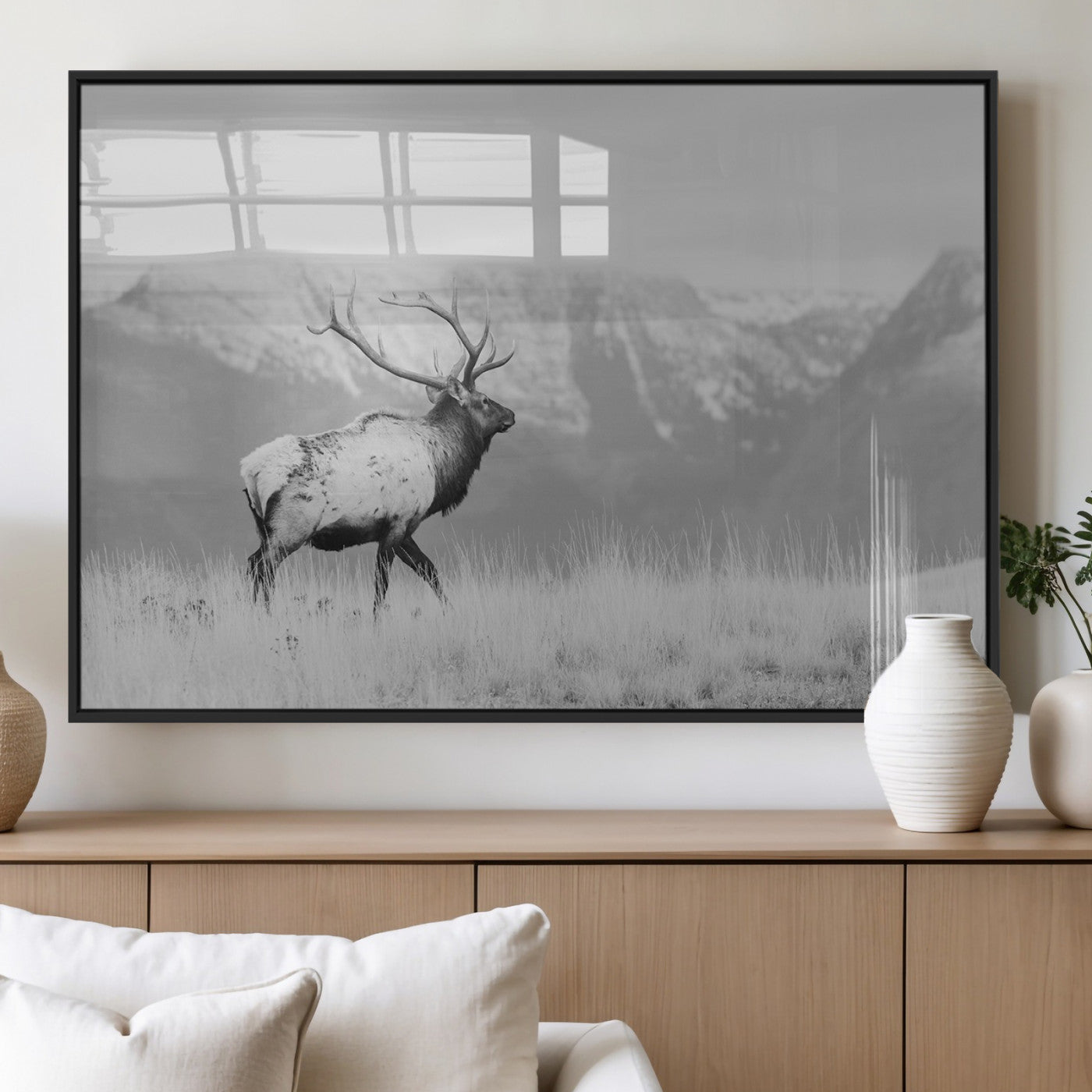Black and white elk standing in front of snowy mountain range, perfect for rustic lodge or nature-inspired wall decor.