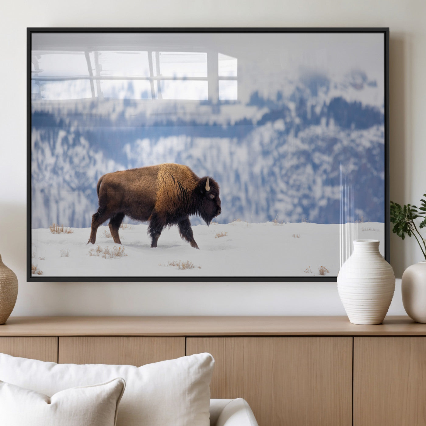 A lone bison walks across snowy ground with blue-toned mountain range behind, ideal for rustic or western farmhouse interiors.