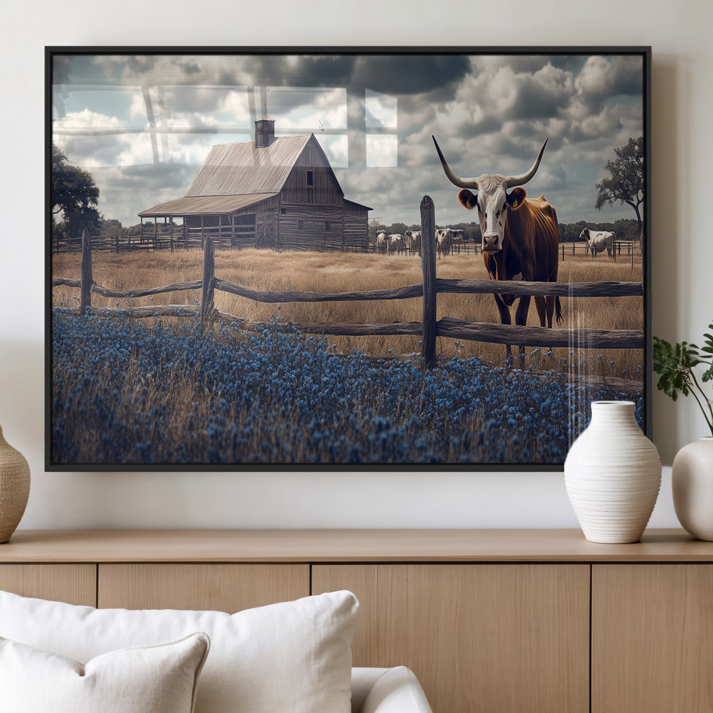 Framed canvas art of a Texas Longhorn cow near a rustic barn and bluebonnet field, ideal for country-style or farmhouse wall decor.