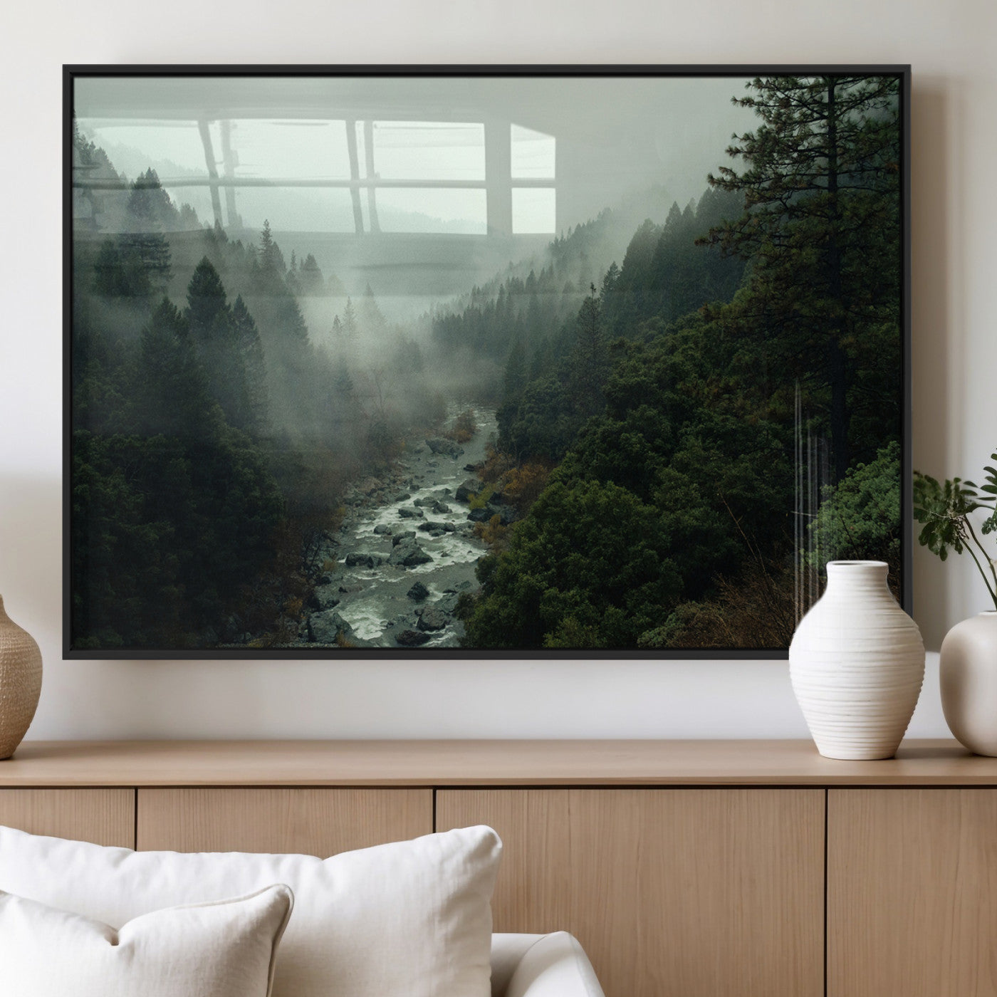 Misty forest with a winding river flowing through lush green mountains, creating a tranquil and moody wilderness landscape.