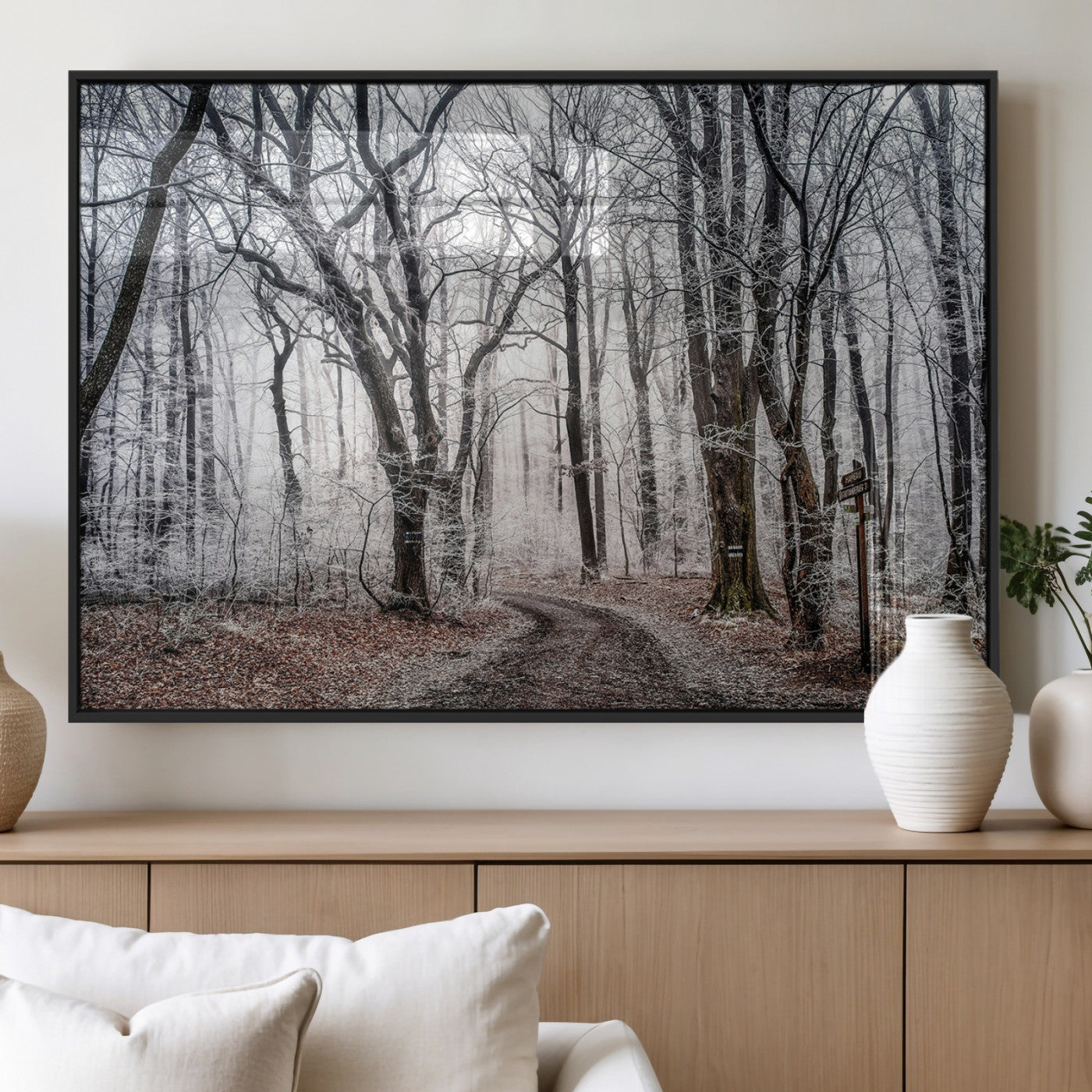 Snow-covered trees in a misty winter forest with a winding path, creating a serene and mysterious atmosphere, perfect for nature-inspired wall art.