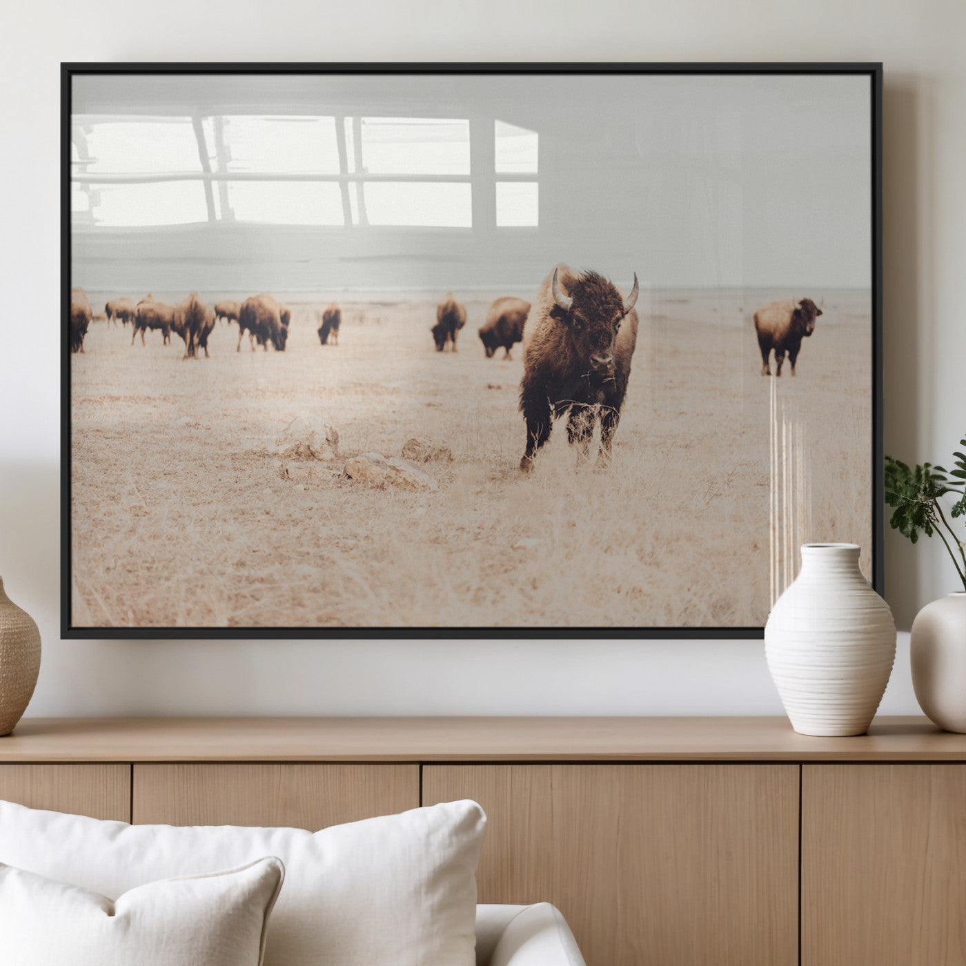 Herd of bison roaming a vast prairie with golden grass under a soft sky, creating a rustic and Western landscape, ideal for wall art.