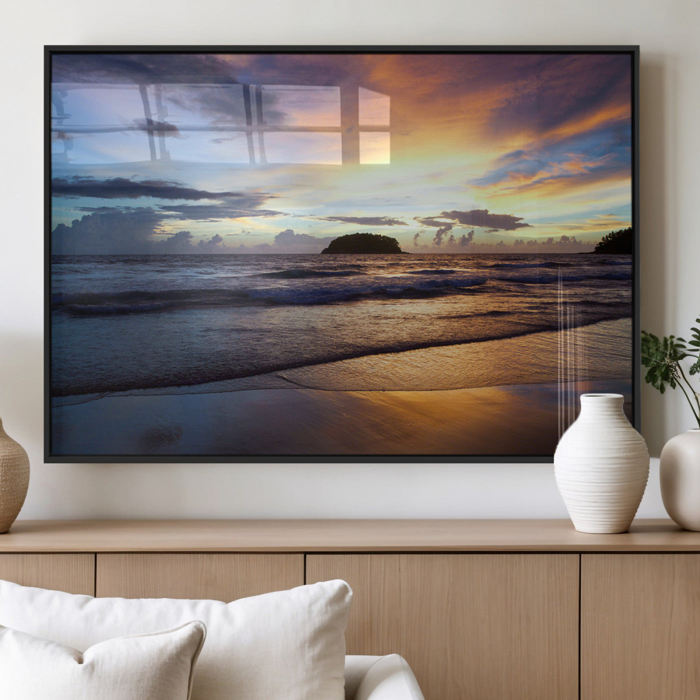 A tropical beach at sunset with waves gently washing ashore, reflecting golden and purple hues in the sky, creating a tranquil coastal scene.