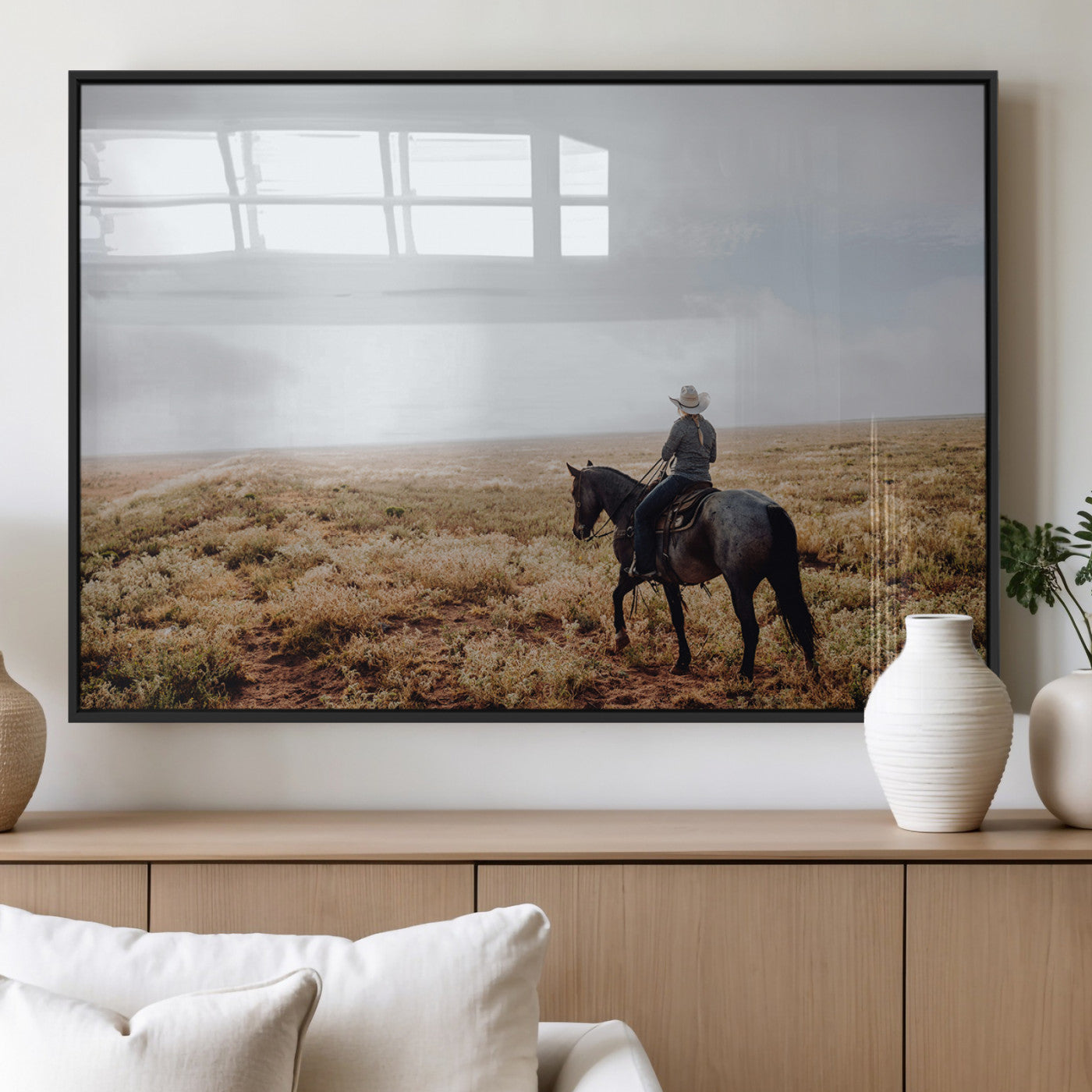 A lone cowboy riding horseback across an open prairie under a vast sky, capturing the rugged and timeless spirit of the Western frontier.