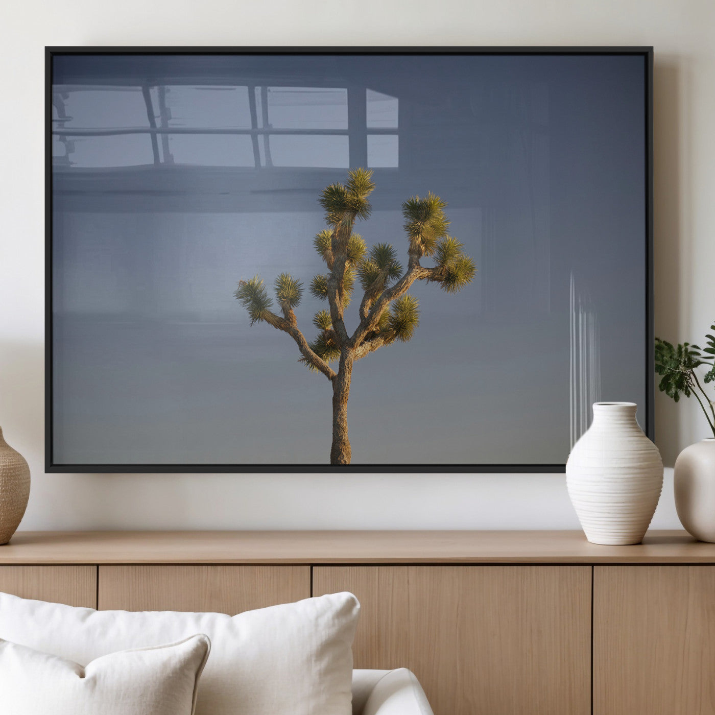 A lone Joshua Tree standing against a deep blue sky, capturing the serene and rugged beauty of the Southwestern desert landscape.