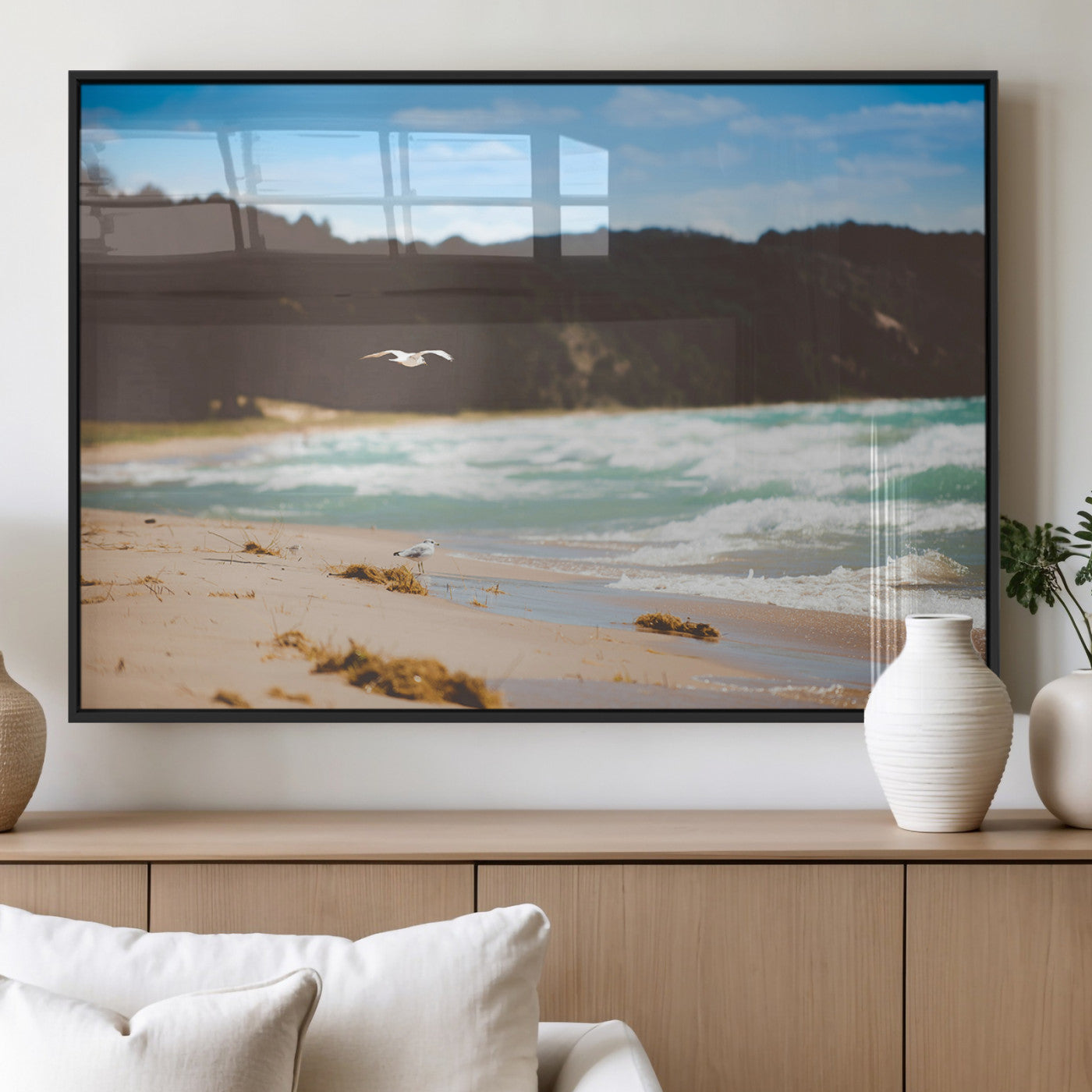 Serene beach scene with gentle ocean waves, sandy shore, and a seagull flying under a blue sky, perfect for coastal and nature-inspired decor.