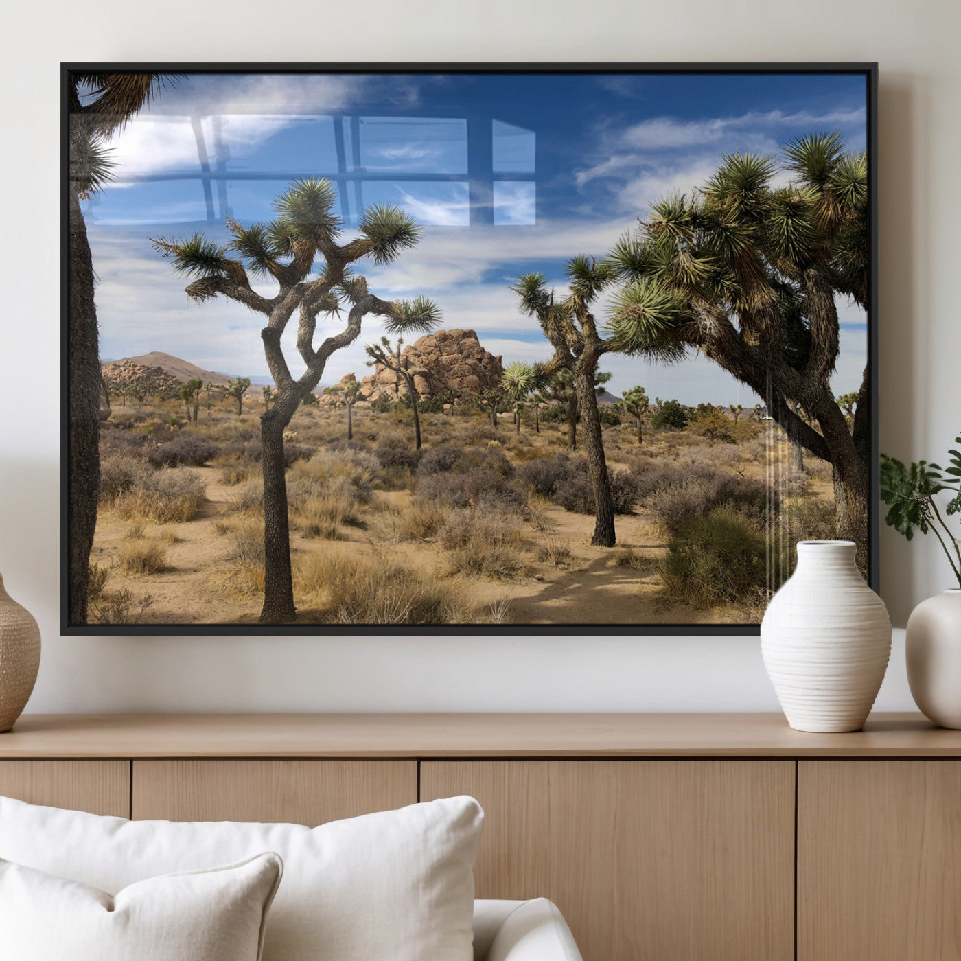 Scenic Joshua Tree landscape with rugged desert terrain, golden dry grass, and a deep blue sky, creating a warm, rustic Southwestern aesthetic.