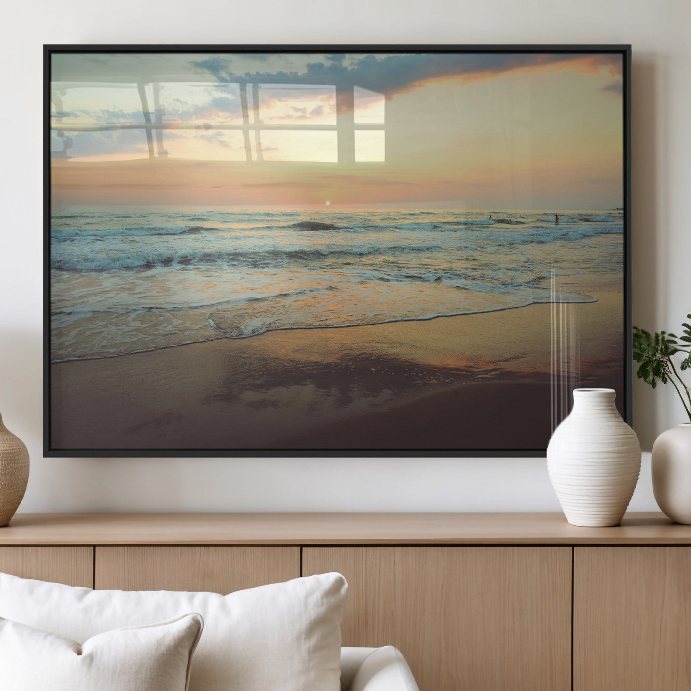 Warm sunset over gentle ocean waves with pastel sky and reflections on wet sand, creating a calm and soothing beach ambiance.