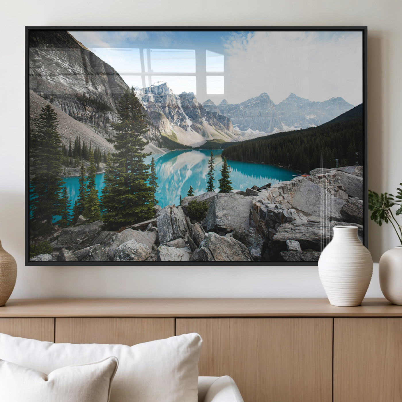 Stunning view of Moraine Lake with turquoise waters reflecting snow-capped mountains and evergreen trees, creating a peaceful alpine decor.