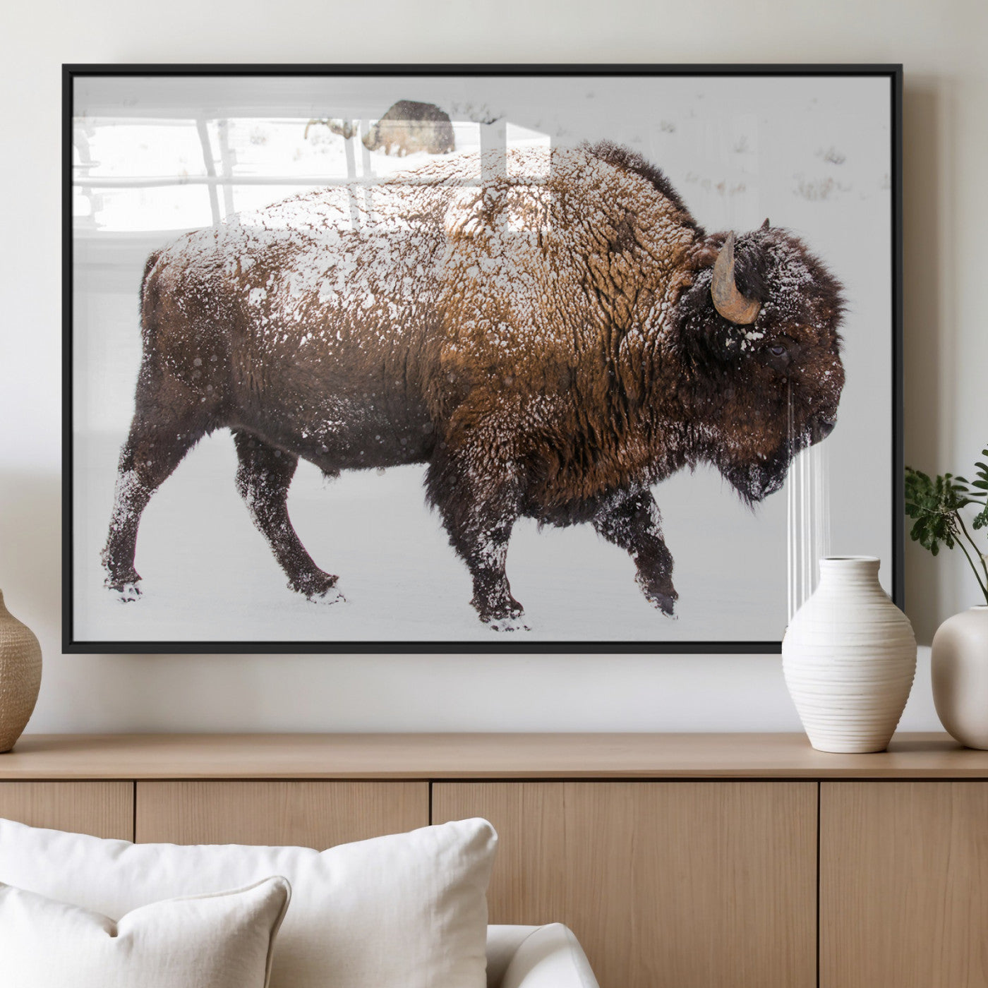 Side profile of a powerful bison walking through deep snow, with frost-covered fur and a white winter background, perfect for rustic and western decor.