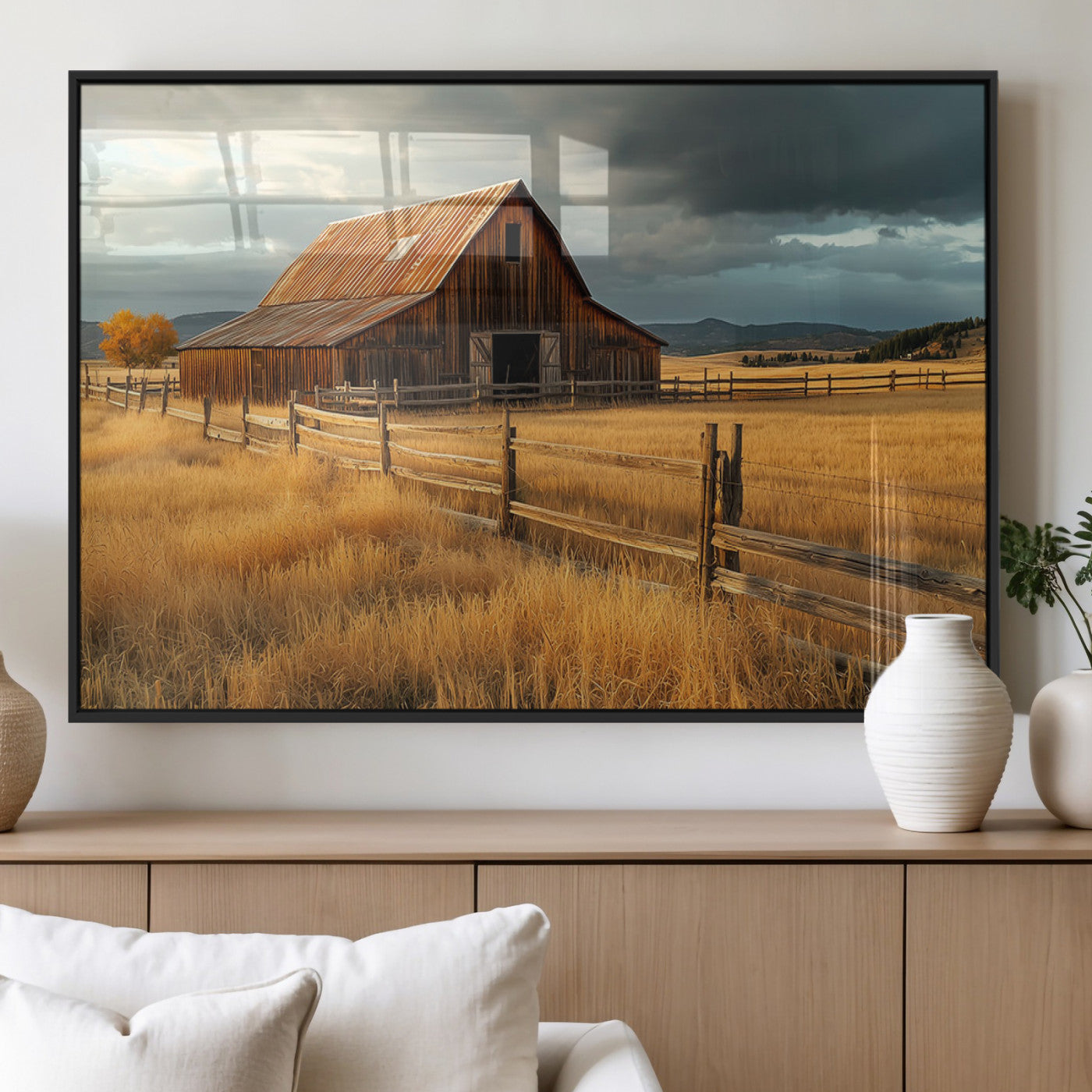 "Golden fields surrounding a rustic barn with a weathered roof, a wooden fence, and dramatic skies with sunlight breaking through the clouds."
