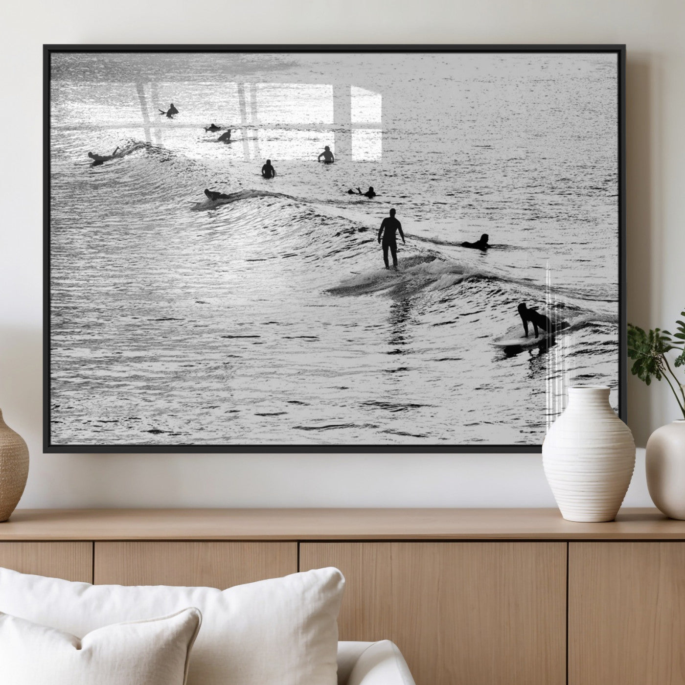 19970637-MGV-CV-60X30-3P_Black-Black and white artistic view of surfers riding and paddling on waves in the ocean, capturing the dynamic motion and energy of surfing