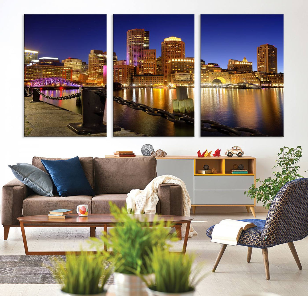 The "Boston City Night Skyline Cityscape View Wall Art Canvas Print" beautifully portrays a stunning triptych of a city skyline illuminated against the night sky, elegantly reflected in the river below. These museum-quality canvases are gallery wrapped to ensure an elegant presentation that enhances any space.