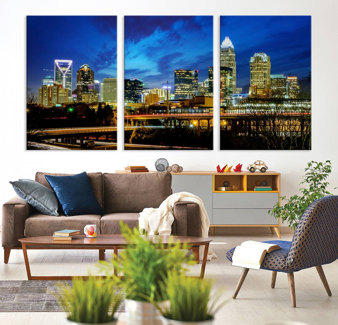 A modern living room highlighted by the "Charlotte City Lights Cloudy Blue Night Skyline Cityscape View" wall art canvas print, crafted on museum-quality canvas with UV-protective coating.