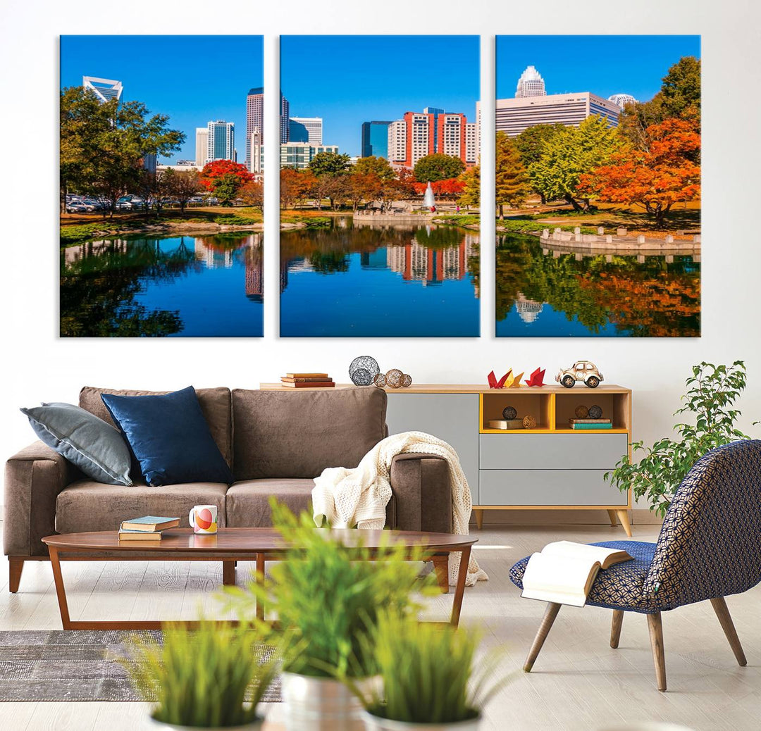 The "Charlotte City Autumn Morning Blue Skyline Cityscape View Wall Art Canvas Print" showcases a cityscape with vibrant autumn trees reflected in a lake. Its gallery-wrapped edges add depth to the scene, while the UV-protective coating ensures lasting brilliance.