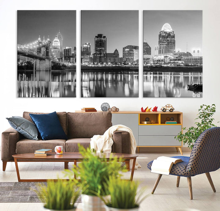 The "Cincinnati City Lights Skyline Black and White Wall Art Cityscape Canvas Print" is elegantly displayed in a stylish living room.