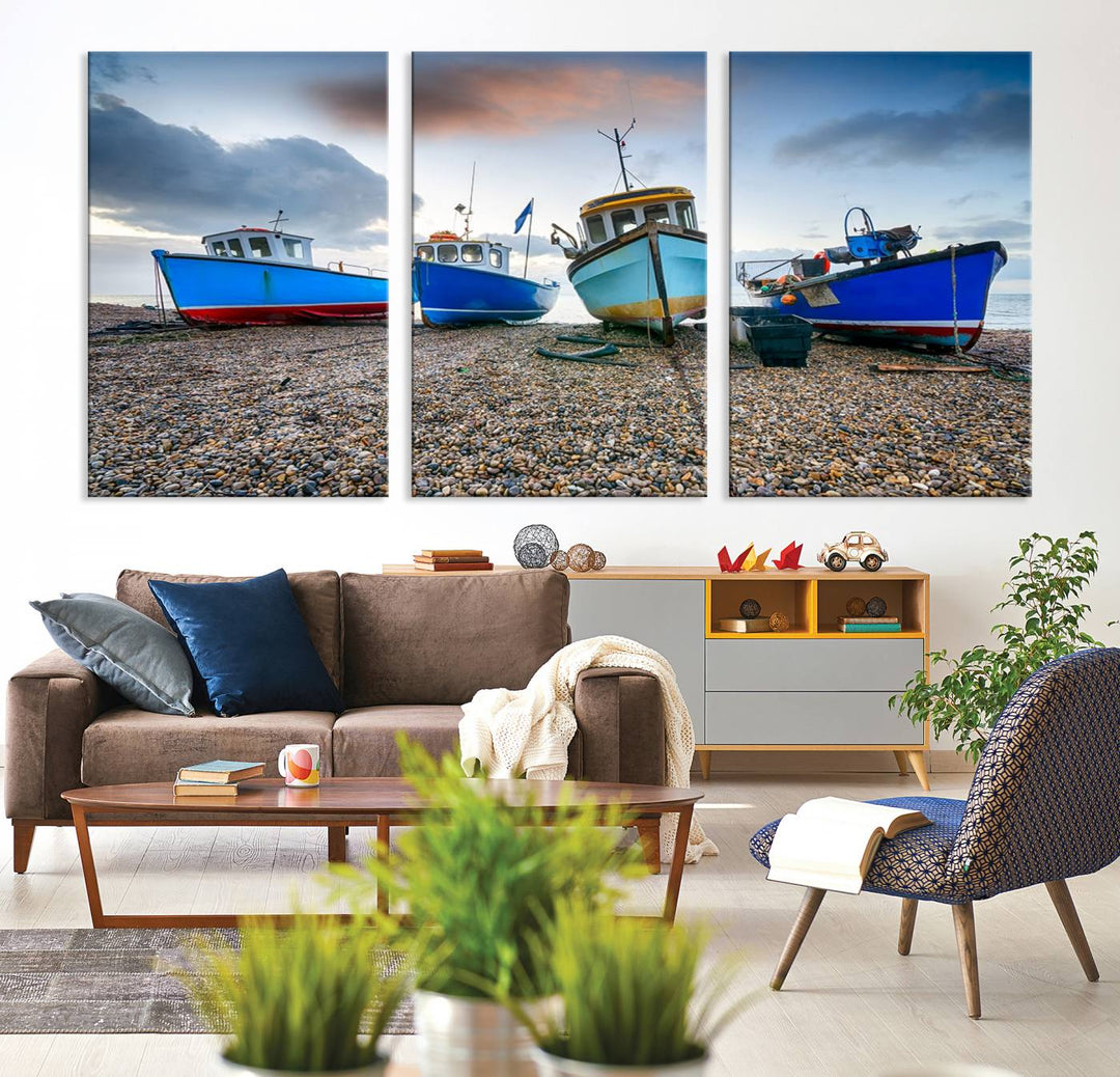 The "Big Boats On The Beach Wall Art Canvas Print" is a stunning piece featuring three museum-quality panels depicting fishing boats on a pebbled shore. Ready to hang and featuring UV-protective coating, it serves as an elegant addition to your home décor.