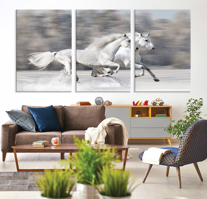 The "All The White Horses Wall Art Canvas Print" depicts a triptych of galloping white horses across a snowy landscape. These museum-quality canvases come with a UV-protective coating to maintain their stunning appearance over time.