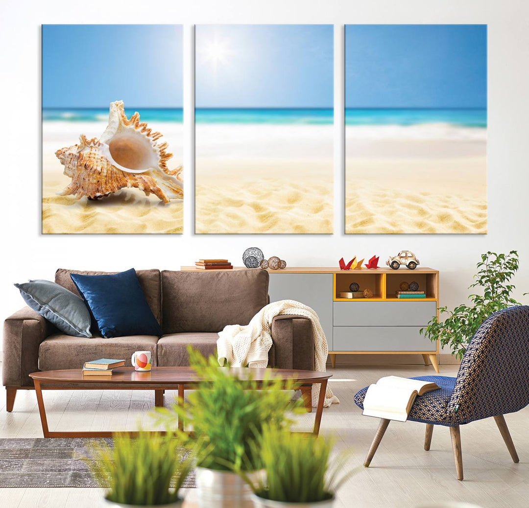 The Sea Shell on The Beach Sun Sand Wall Art Canvas Print is a triptych that beautifully captures a beach scene with a large seashell on the sand.