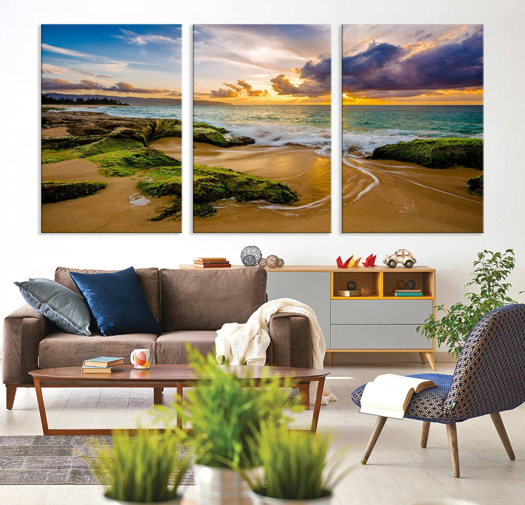 The Sunset Beach Wall Art Canvas Print is a gallery-wrapped triptych showcasing a beach scene with mossy rocks and a vibrant sunset. Made from museum-quality canvas and featuring a UV-protective coating, it elegantly provides both beauty and durability.